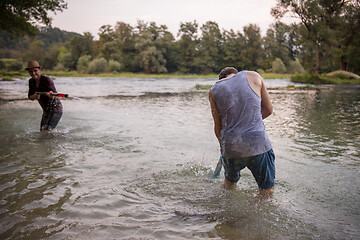 Image showing young men having fun with water guns