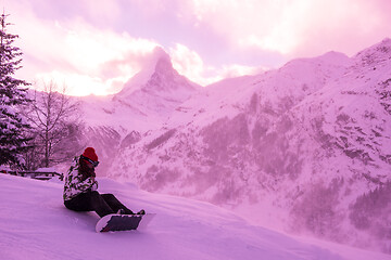 Image showing rescue team with a red helicopter rescuing a hurt skier