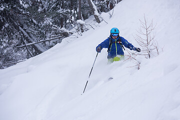 Image showing freeride skier skiing downhill