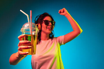 Image showing Happy young woman standing and smiling against blue background