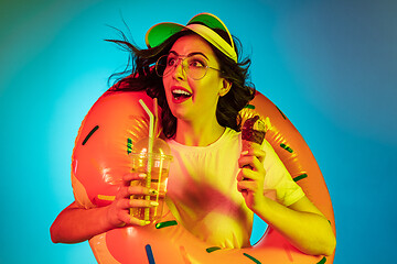 Image showing Happy young woman standing and smiling against blue background