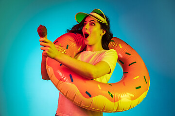 Image showing Happy young woman standing and smiling against blue background