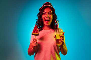 Image showing Happy young woman standing and smiling against blue background