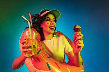 Image showing Happy young woman standing and smiling against blue background