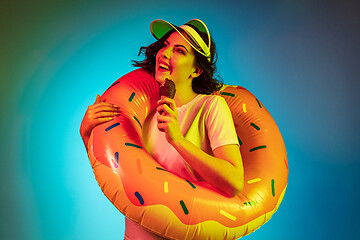 Image showing Happy young woman standing and smiling against blue background