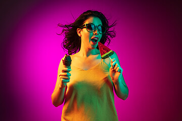 Image showing Happy young woman standing and smiling against pink background