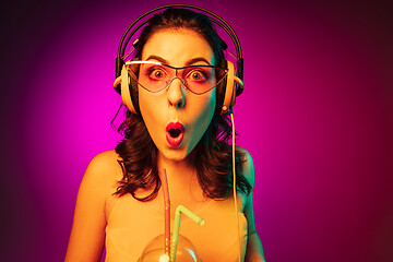 Image showing Happy young woman standing and smiling against pink background