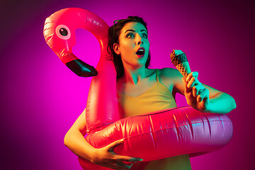 Image showing Happy young woman standing and smiling against pink background