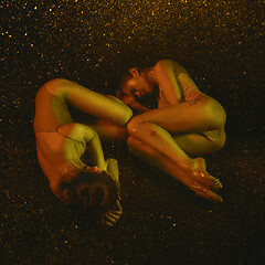 Image showing Two young female ballet dancers under water drops