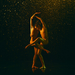 Image showing Two young female ballet dancers under water drops