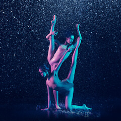 Image showing Two young female ballet dancers under water drops