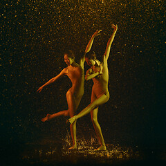 Image showing Two young female ballet dancers under water drops