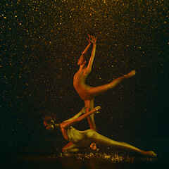 Image showing Two young female ballet dancers under water drops