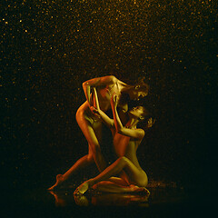 Image showing Two young female ballet dancers under water drops