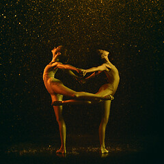 Image showing Two young female ballet dancers under water drops