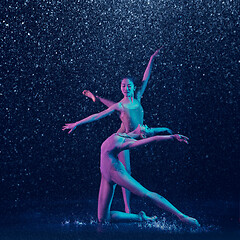 Image showing Two young female ballet dancers under water drops