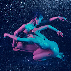 Image showing Two young female ballet dancers under water drops