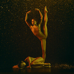 Image showing Two young female ballet dancers under water drops