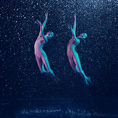 Image showing Two young female ballet dancers under water drops