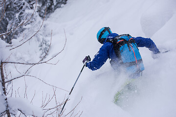 Image showing freeride skier skiing downhill