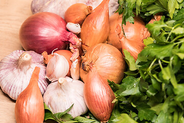 Image showing garlic onion shallot parsley on a wooden board