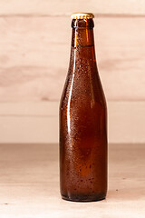 Image showing a bottle of amber beer with its capsule