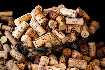 Image showing old cork stoppers of French wines in a wire basket