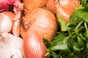 Image showing garlic onion shallot parsley on a wooden board