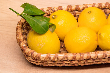 Image showing yellow lemons in a small wooden basket