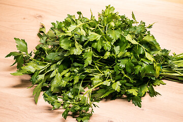 Image showing bunch of fresh parsley on a wooden board