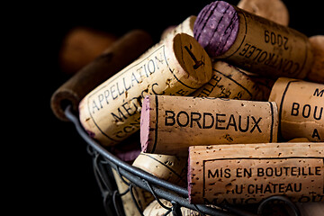 Image showing old cork stoppers of French wines in a wire basket