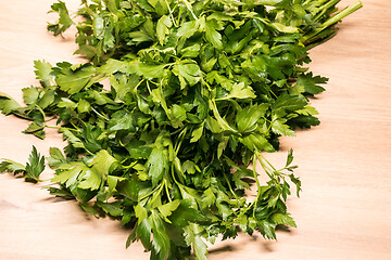 Image showing bunch of fresh parsley on a wooden board