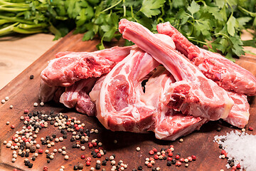 Image showing raw lamb chops on a wooden board for barbecue