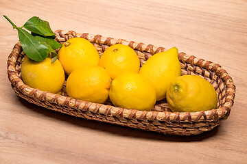 Image showing yellow lemons in a small wooden basket