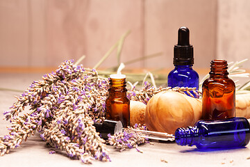 Image showing lavender mortar and pestle and bottles of essential oils for aro