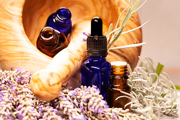 Image showing lavender mortar and pestle and bottles of essential oils for aro