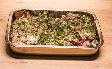 Image showing raw meats marinated in garlic olive oil parsley salt pepper