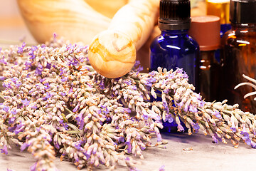 Image showing lavender mortar and pestle and bottles of essential oils for aro