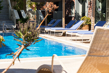 Image showing private pool and sun loungers in the sun