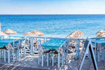 Image showing restaurant terrace in front of the beach in kamari on the island