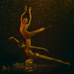 Image showing Two young female ballet dancers under water drops