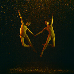 Image showing Two young female ballet dancers under water drops