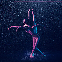 Image showing Two young female ballet dancers under water drops