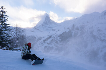 Image showing rescue team with a red helicopter rescuing a hurt skier