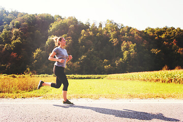 Image showing woman jogging along a country road