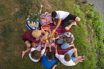 Image showing top view of group friends enjoying picnic time