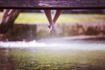 Image showing people sitting at wooden bridge