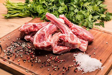 Image showing raw lamb chops on a wooden board for barbecue