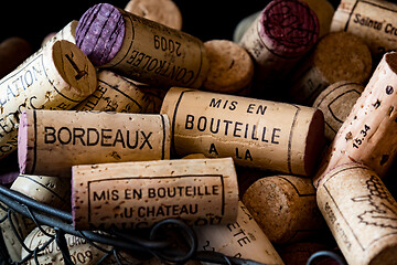 Image showing old cork stoppers of French wines in a wire basket