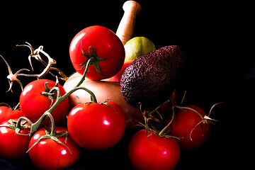 Image showing large red and ripe tomatoes with a mortar and pestle in olive wo